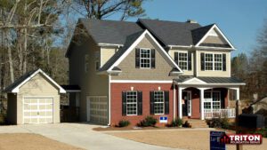 two-story suburban home with a combination of brick and siding exterior, featuring a neatly landscaped front yard